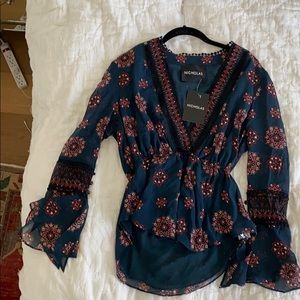 Top with 3 quarter length sleeves.